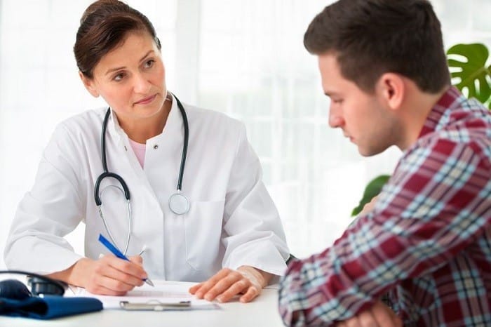 Vaccinated - A doctor talks with a patient.