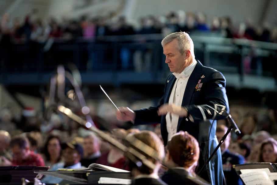 A conductor controls an orchestra.