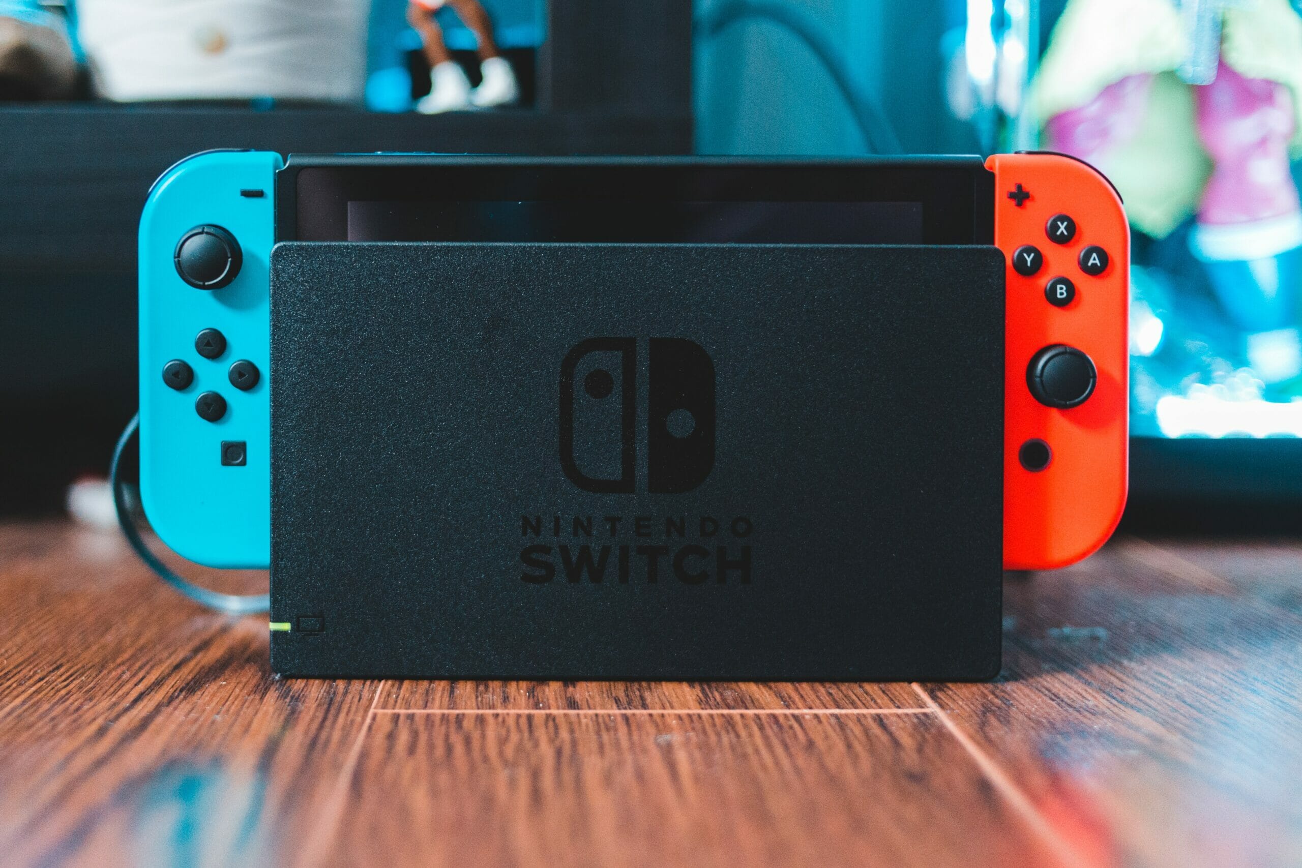 A picture of the original Nintendo Switch in its black dock.