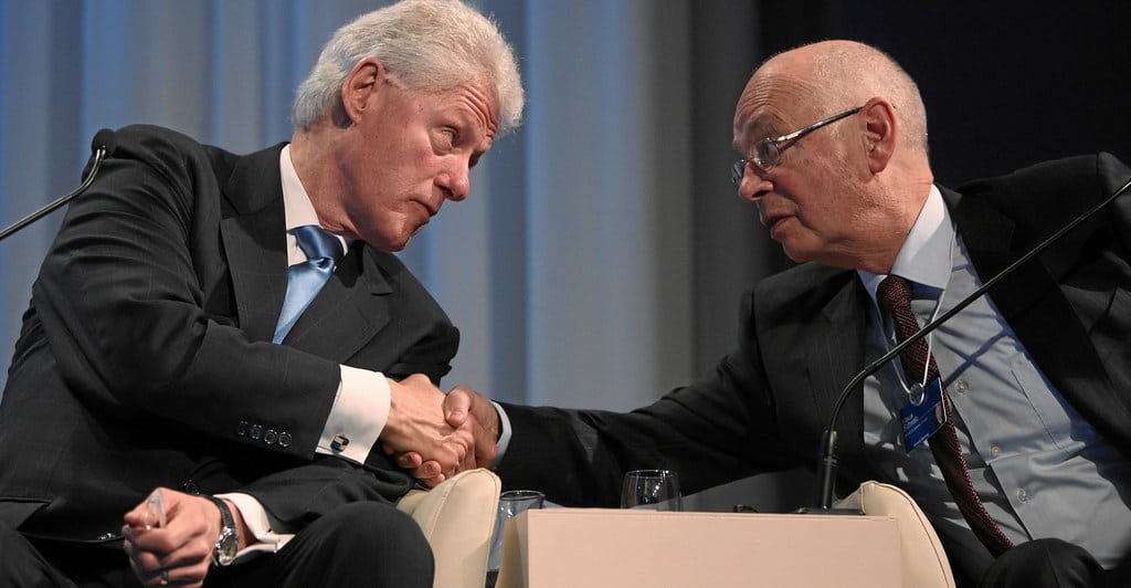Klaus Schwab (right) shaking hands with Bill Clinton at World Economic Forum Annual Meeting in 2010