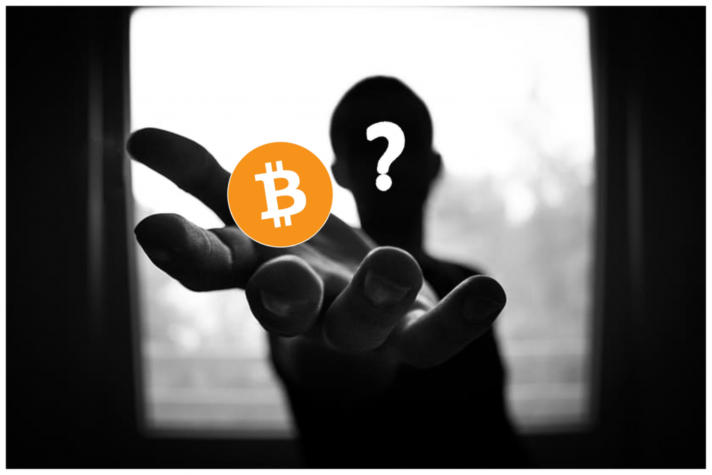 A silhouetted man holding Bitcoin logo in his hand