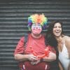 man dressed as a clown standing with a woman