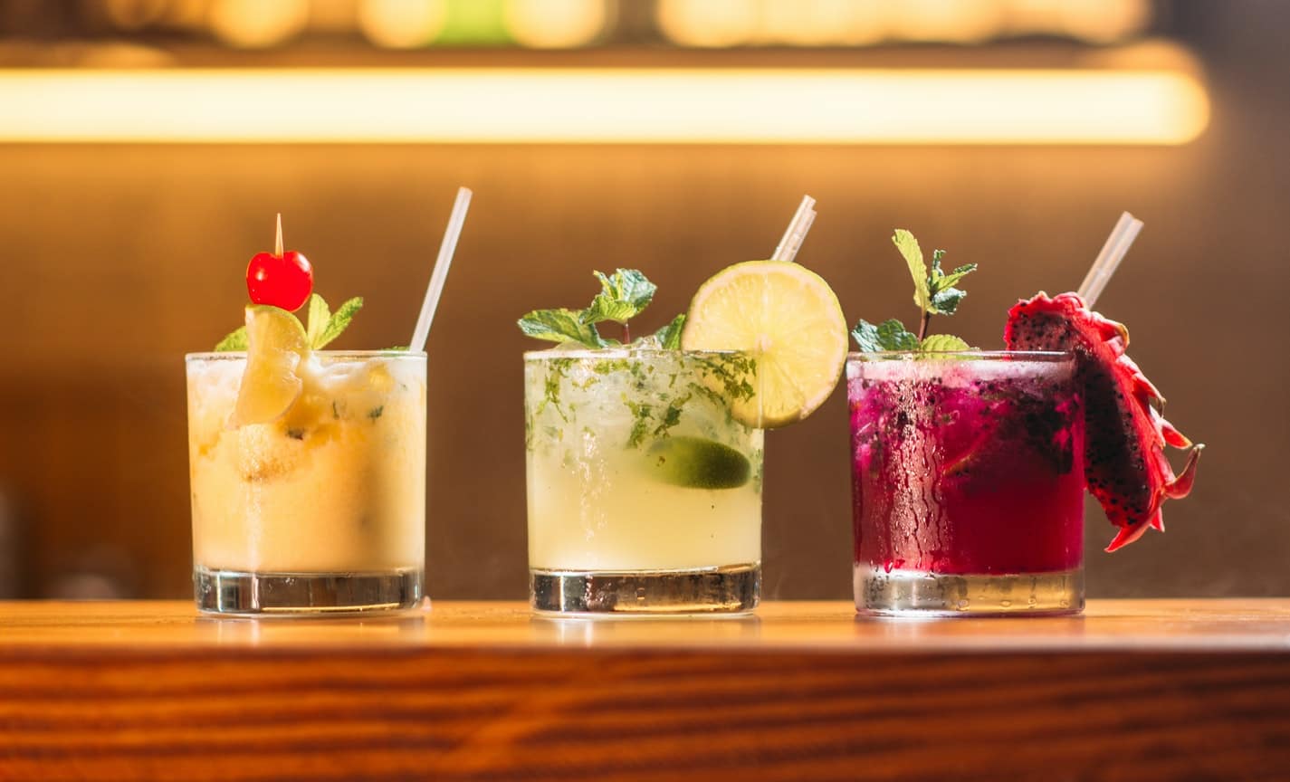 three cocktails at a bar top
