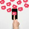 A flurry of hearts emerging from smart phone.