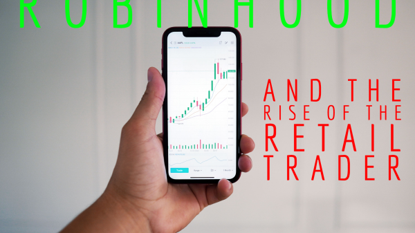 A hand holding a phone showing a chart of a stock - Robinhood and the rise of the retail investor