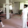 Female fitness instructor helping women in the gym.