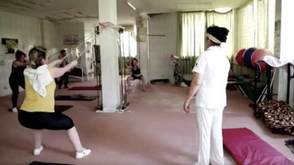 Female fitness instructor helping women in the gym.