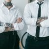 Tattooed man and woman wearing professional attire at work