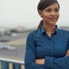 Confident happy Black woman standing outside with arms folded