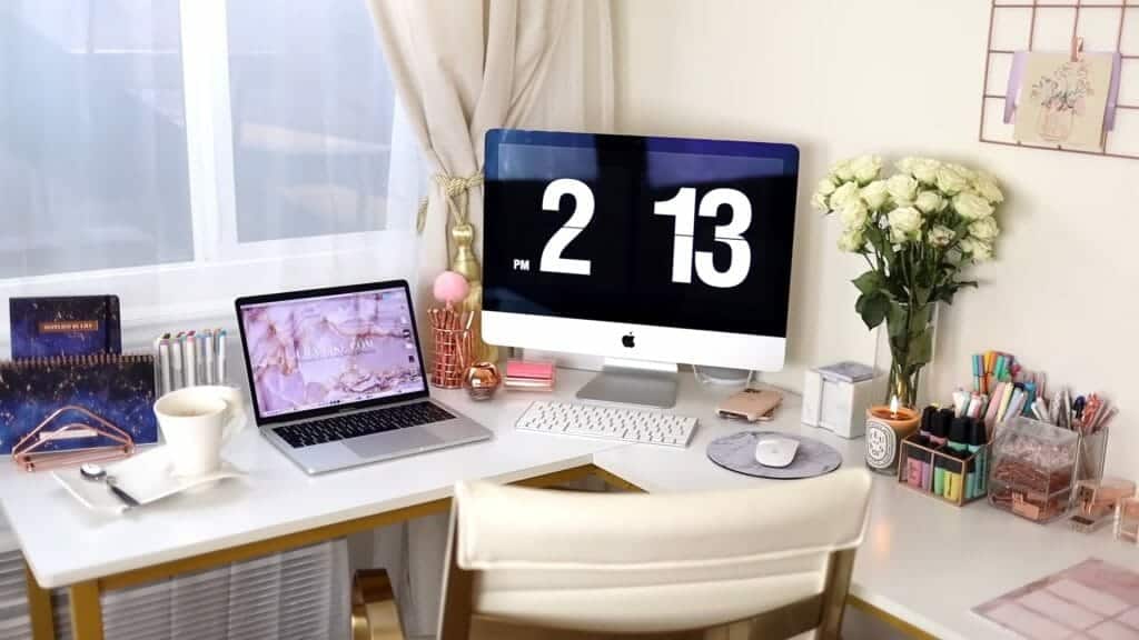 A beautiful study area with a candle, flowers, and pastel writing materials