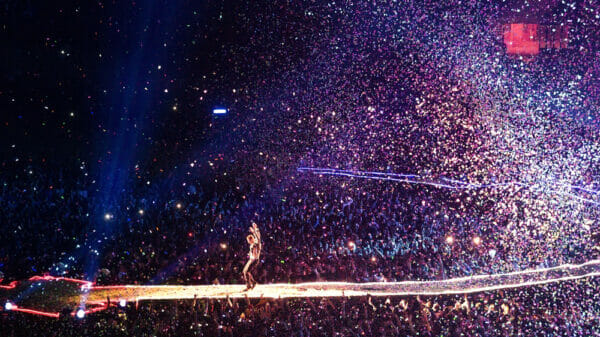 Chris Martin from Coldplay on stage with huge audience and confetti in Madrid