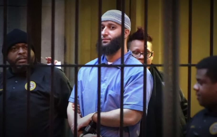 Adnan Syed, handcuffed and with guards, awaits his court appearance.