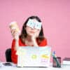 A woman holding a coffee cup bored with her numerous duties at work