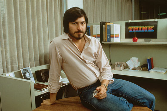 Young Steve Jobs posing for photo.