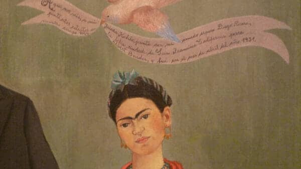 Painting of Frida Kahlo with a bird and banner