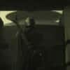 The Mandalorian (Pedro Pascal) stands with his back to the camera