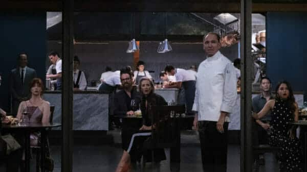 'The Menu's ensemble cast gape through the windows at something horrific occuring.