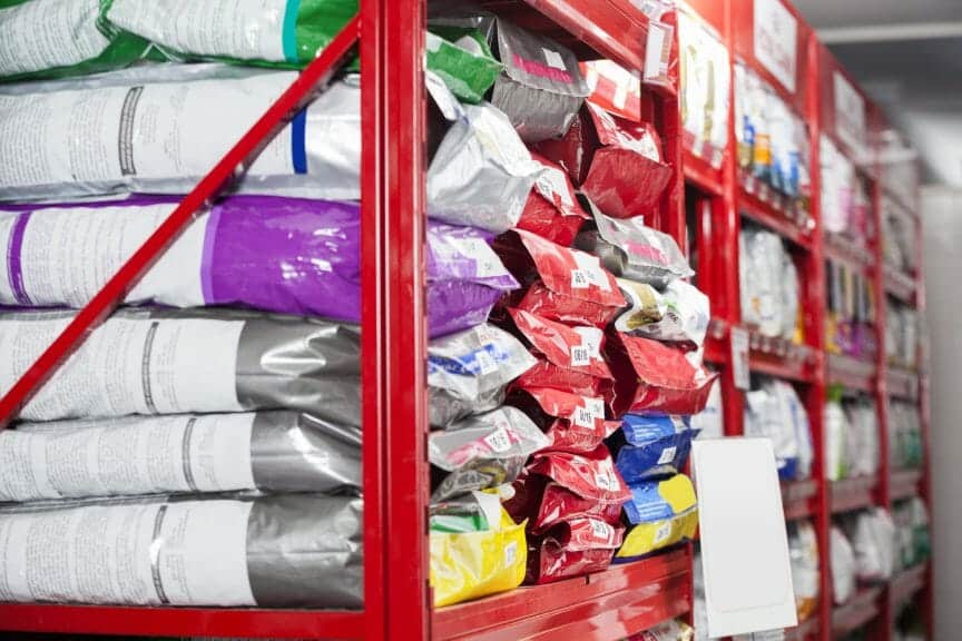 dog food bags sitting on the shelf in a store