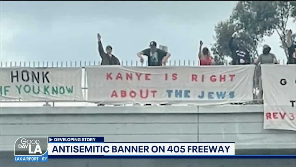 protestors on 405 highway holding sign reading "kanye is right about the jews"