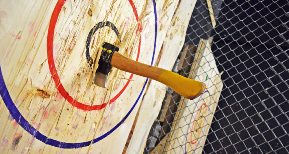 Axe in bullseye of target in an axe throwing activity location