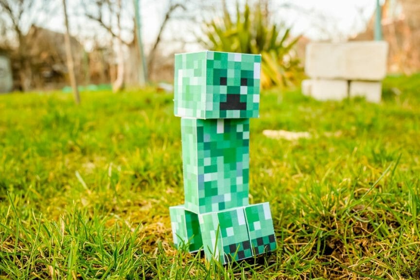 Minecraft Creeper made of paper in grass outside