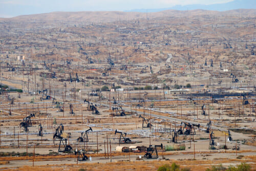 View over oil field in Bakersfiled, California, with derricks pumps.