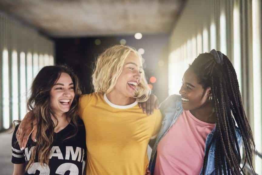 Group of college students having fun and laughing together while walking 