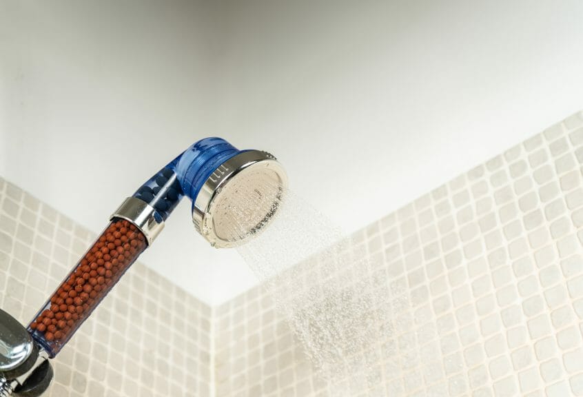 Filtering showerhead in shower.