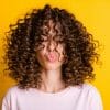 Woman with brown curly hair.