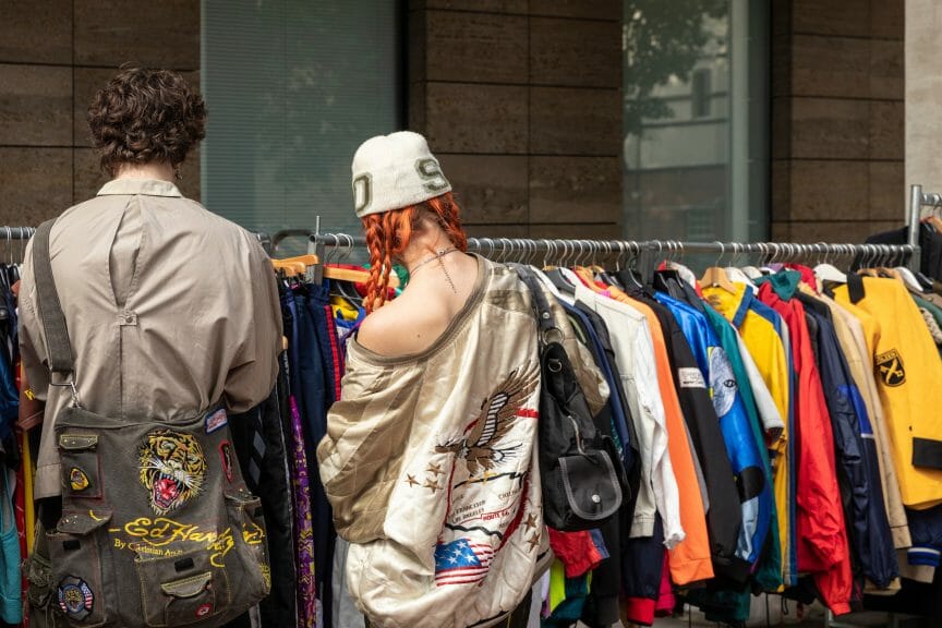 Fashionable couple thrifting at an outdoor thrift store.