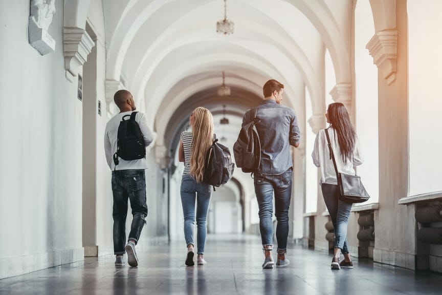 college students walking down hallway