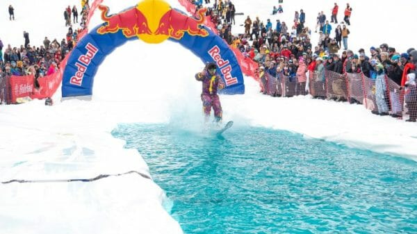 A retro skier glides across the pool of water at the pond skimming event at Holiday Valley in Ellicottville, New York.