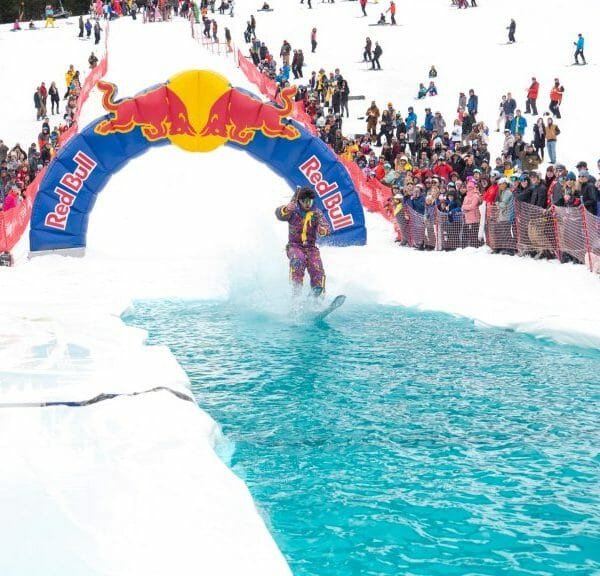 A retro skier glides across the pool of water at the pond skimming event at Holiday Valley in Ellicottville, New York.