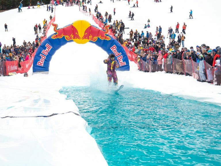 A retro skier glides across the pool of water at the pond skimming event at Holiday Valley in Ellicottville, New York.