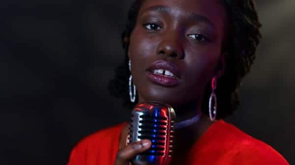 Woman R&B Singer holding microphone and looking at camera