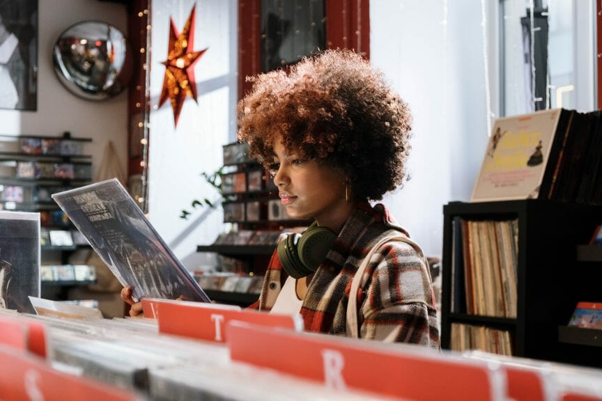 Girl looking at modern music records in a record shop.