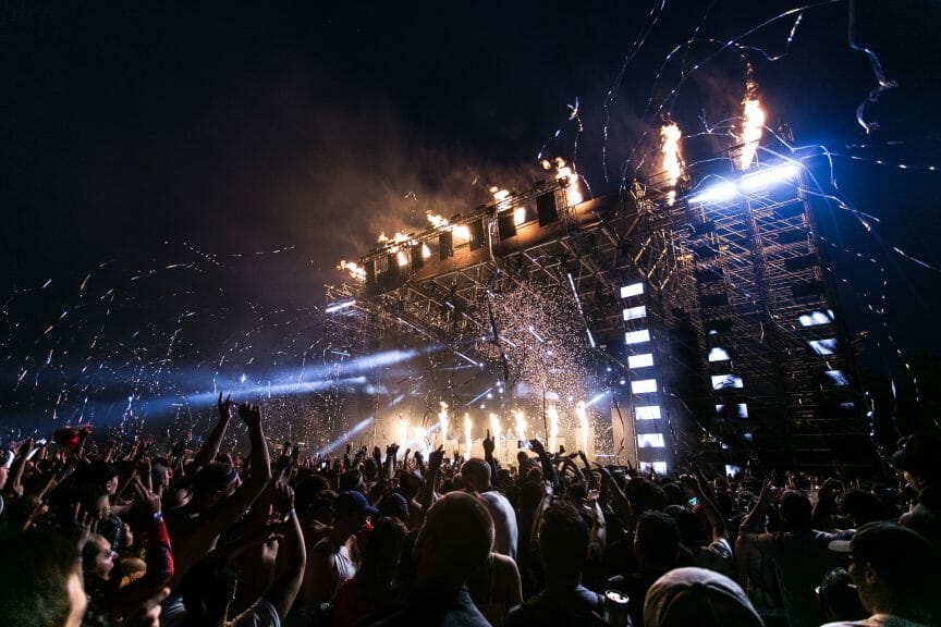 Concert scene with stage and crowd.