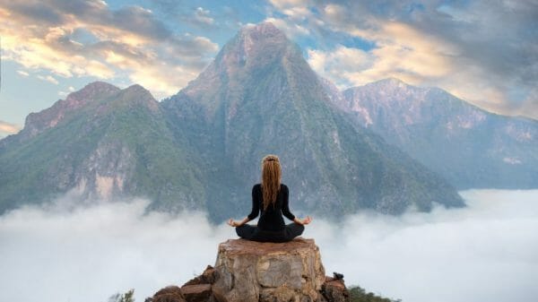 Woman Meditating in the Mountains
