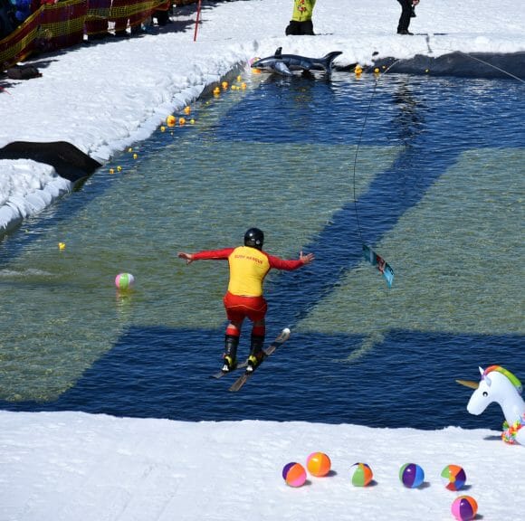 A skier at Perisher Resort in Australia is racing towards the pond of water.
