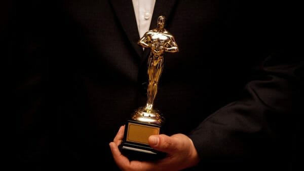 Dressed Up man holding an Oscar