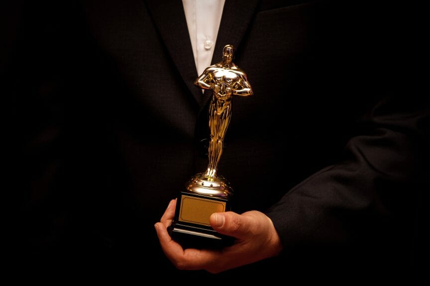 Dressed Up man holding an Oscar
