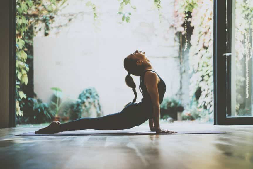 Woman doing yoga inside.