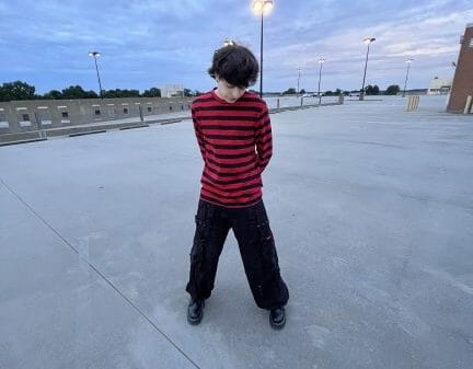 DxnnyFxntom poses for a picture on top of a parking garage.