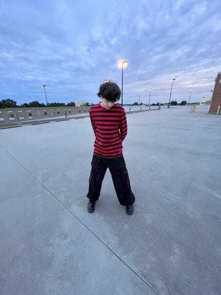 DxnnyFxntom poses for a picture on top of a parking garage.