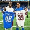 Two NFL players trading jerseys.