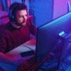 Man sitting in front of computer playing video game