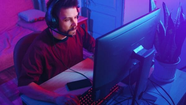 Man sitting in front of computer playing video game