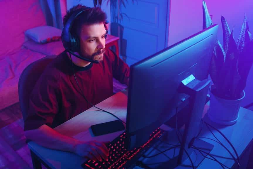 Man sitting in front of computer playing video game