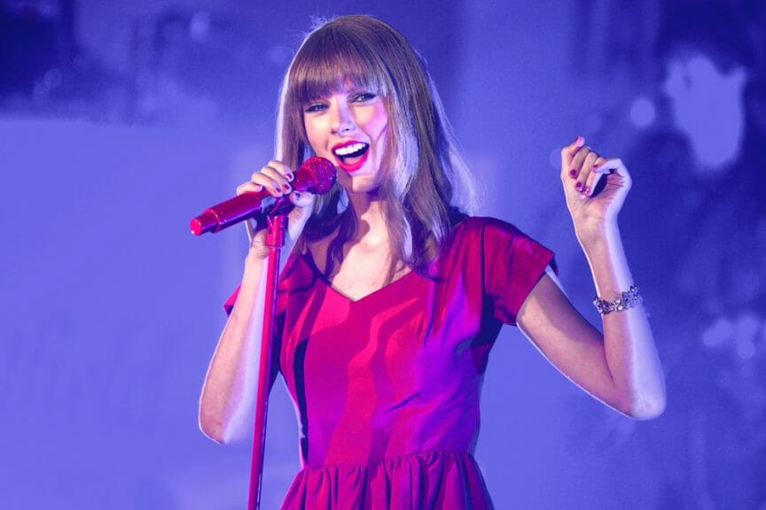 Taylor Swift singing in a red dress