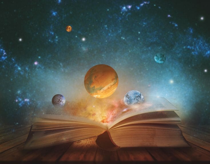 A picture of planets floating above an open book.